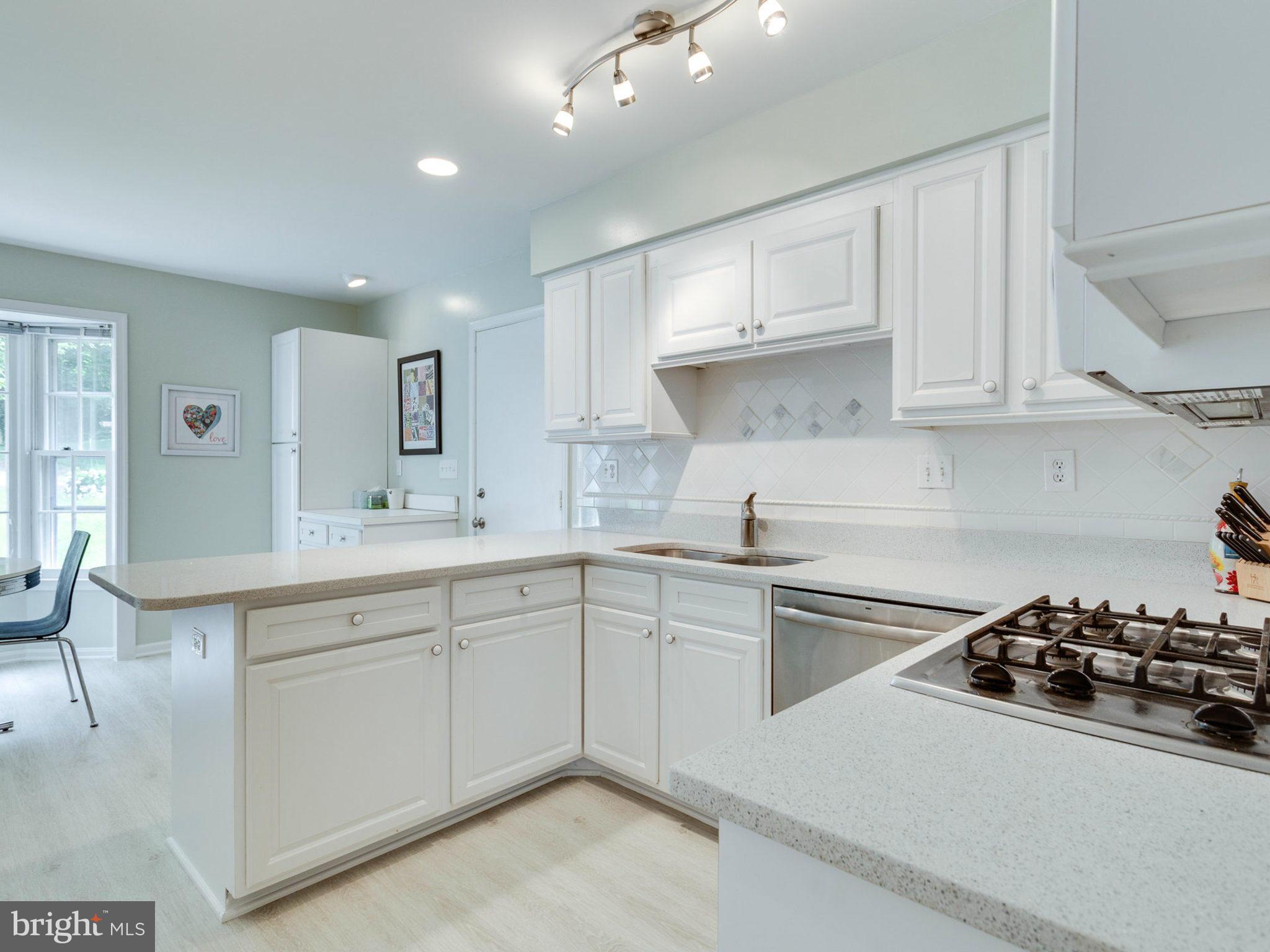 1802 Batten Hollow Road Vienna, VA 22182 - Photo 8 of 30 a kitchen with sink a stove and cabinets