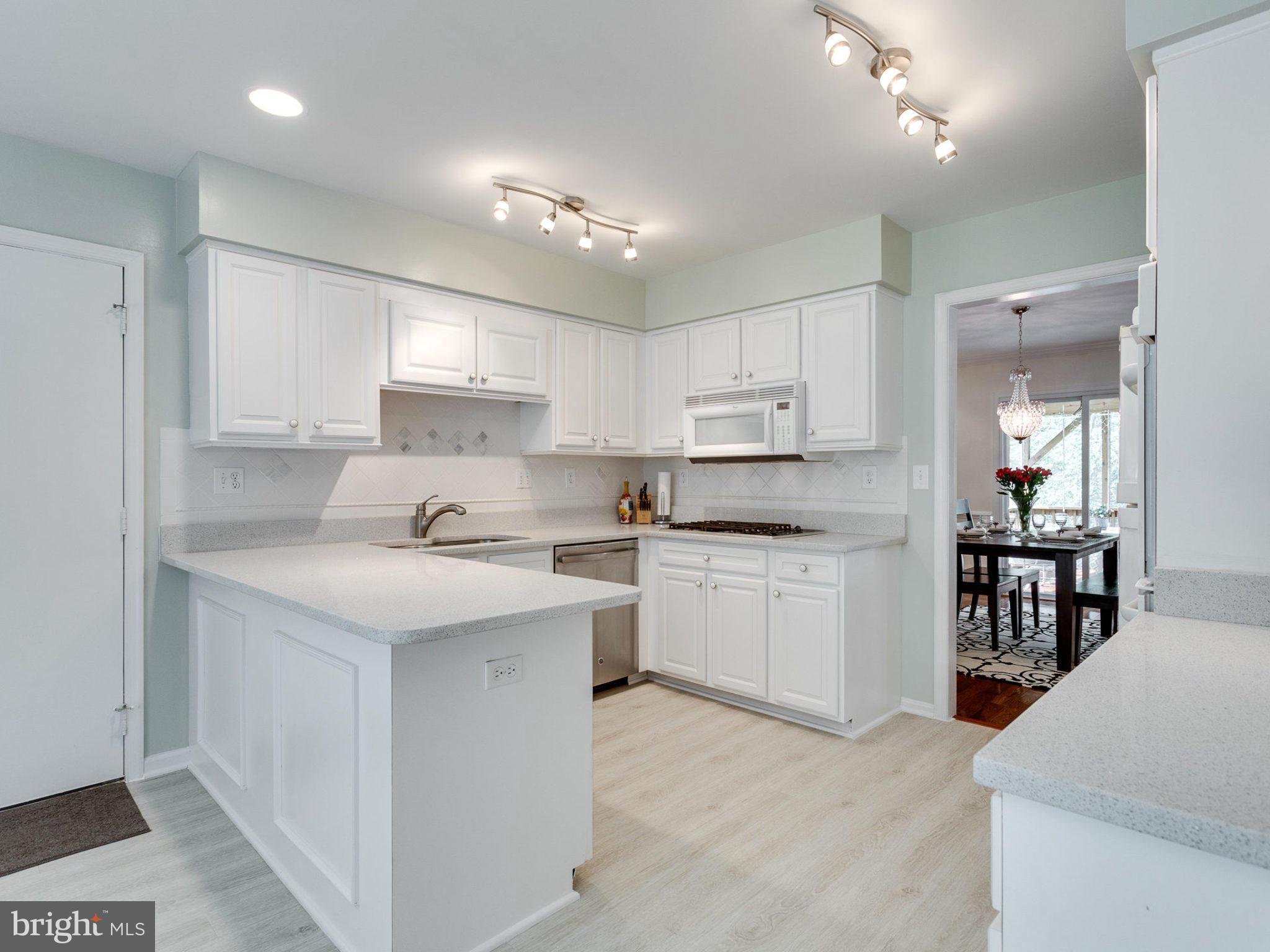 1802 Batten Hollow Road Vienna, VA 22182 - Photo 9 of 30 a kitchen with a sink stove cabinets and refrigerator