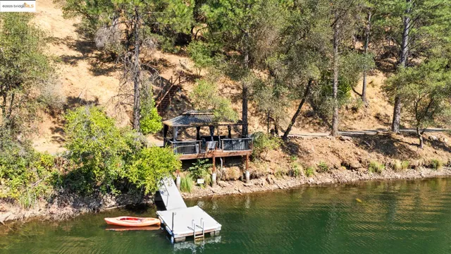 a view of a house with a wooden fence