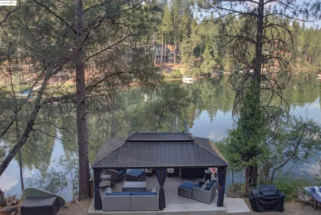 a backyard of a house with table and chairs