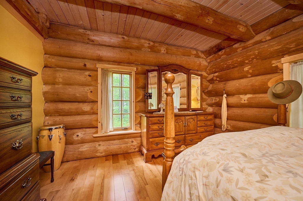 486 Old Stage Road Ashfield, MA 01330 - Photo 16 of 36 a bedroom with a bed and wooden floor