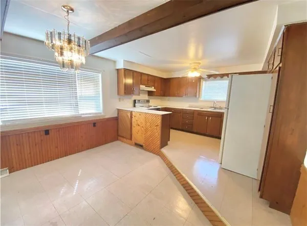 a kitchen with stainless steel appliances granite countertop a sink refrigerator and window
