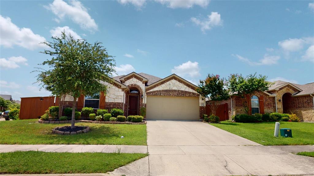 3101 Buckthorn Street Forney, TX 75126 - Photo 1 of 40 Stone and brick facade home featuring an arched entryway, attached garage with a paved driveway, and established front landscaping