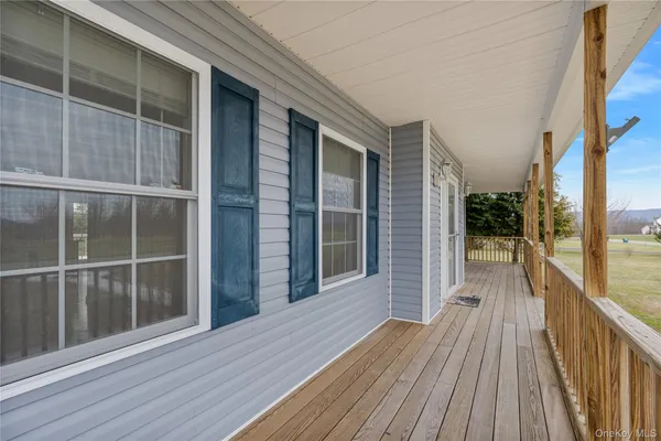 a view of balcony with wooden floor