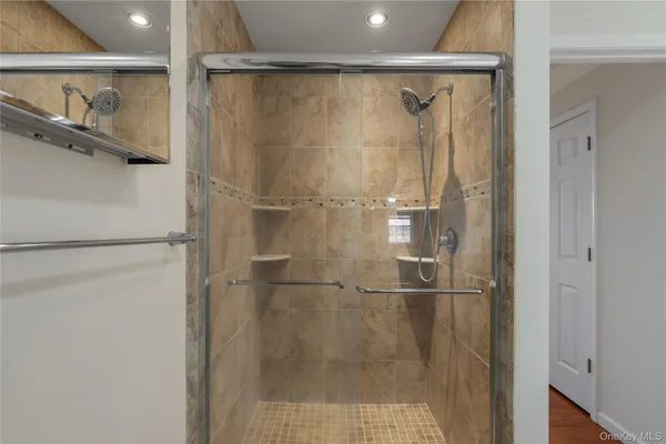 a bathroom with a glass shower door