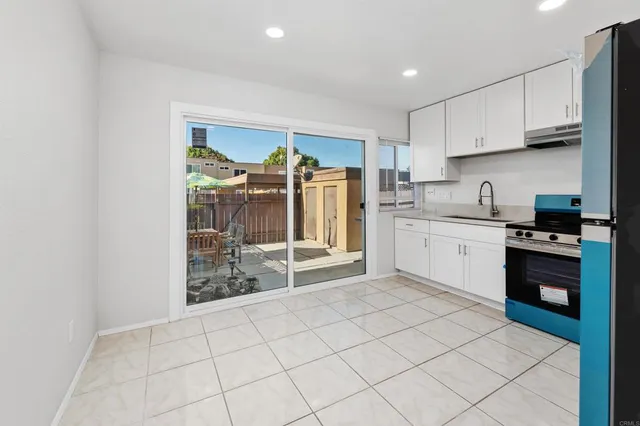 a kitchen with stainless steel appliances granite countertop a refrigerator sink and cabinets