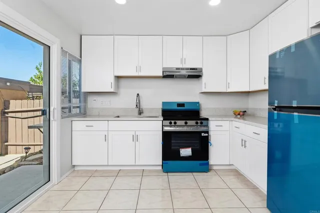 a kitchen with a white cabinets and white appliances