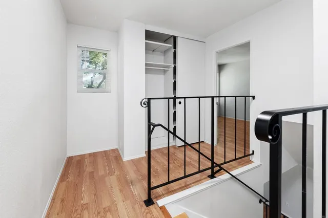 a view of hallway with wooden floor