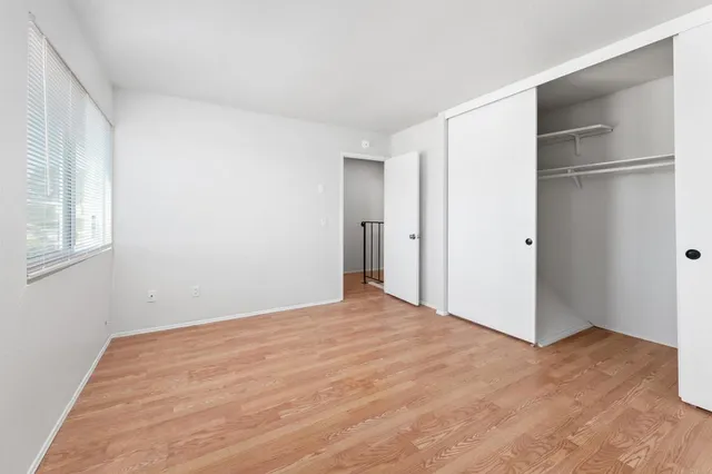 a view of walk in closet with empty racks