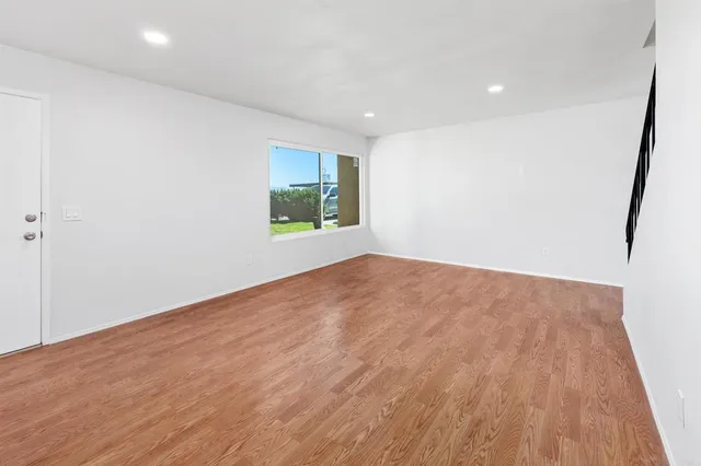 a view of an entryway with wooden floor and stairs