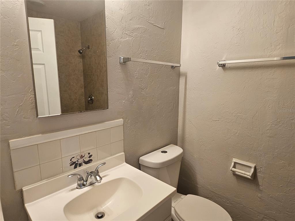 7000 Brentford Road Sarasota, FL 34241 - Photo 23 of 29 a bathroom with a sink mirror and toilet