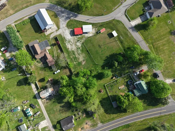 an aerial view of houses with yard