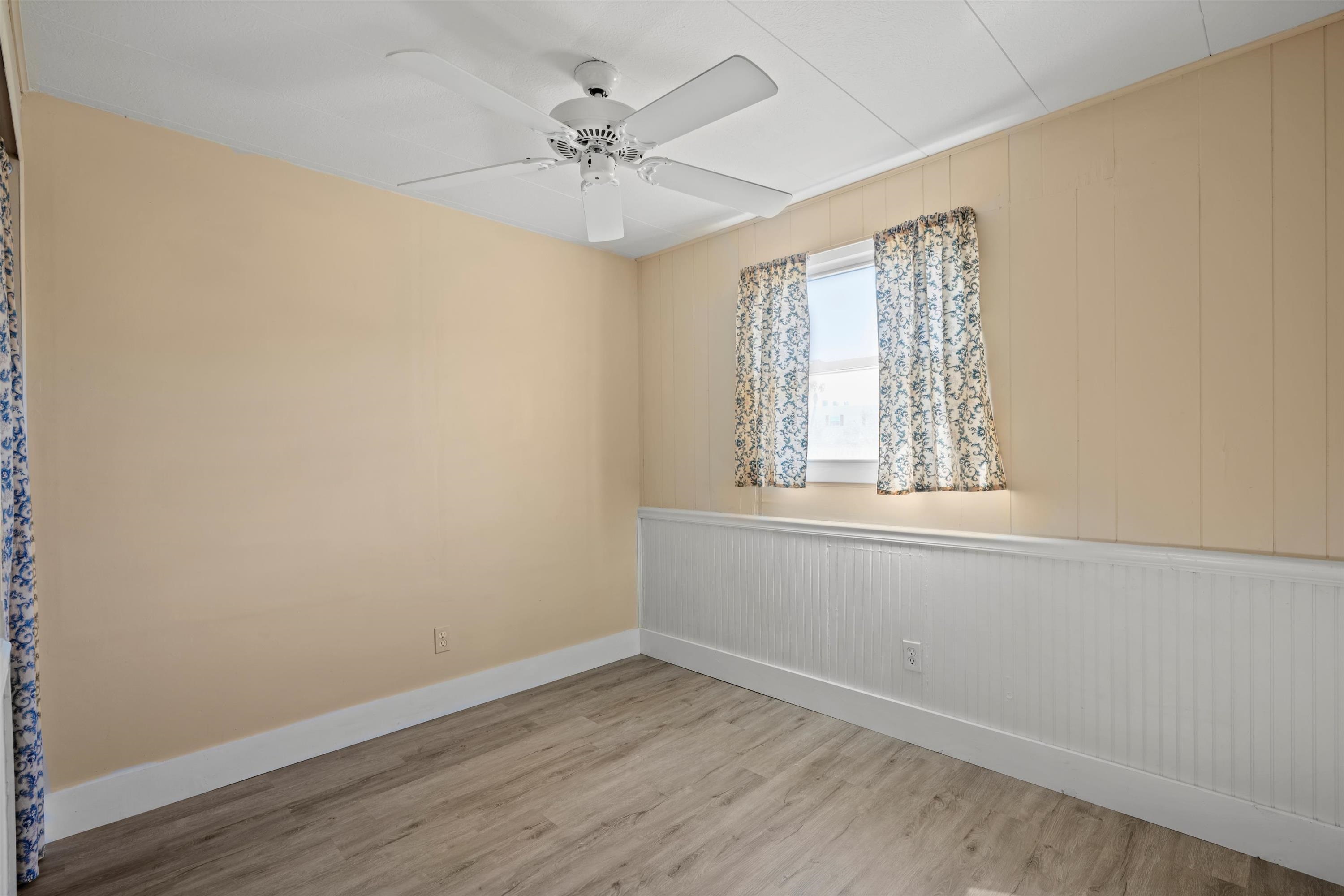 145 Gassett Road St. Augustine, FL 32080 - Photo 20 of 25 an empty room with wooden floor chandelier fan and windows