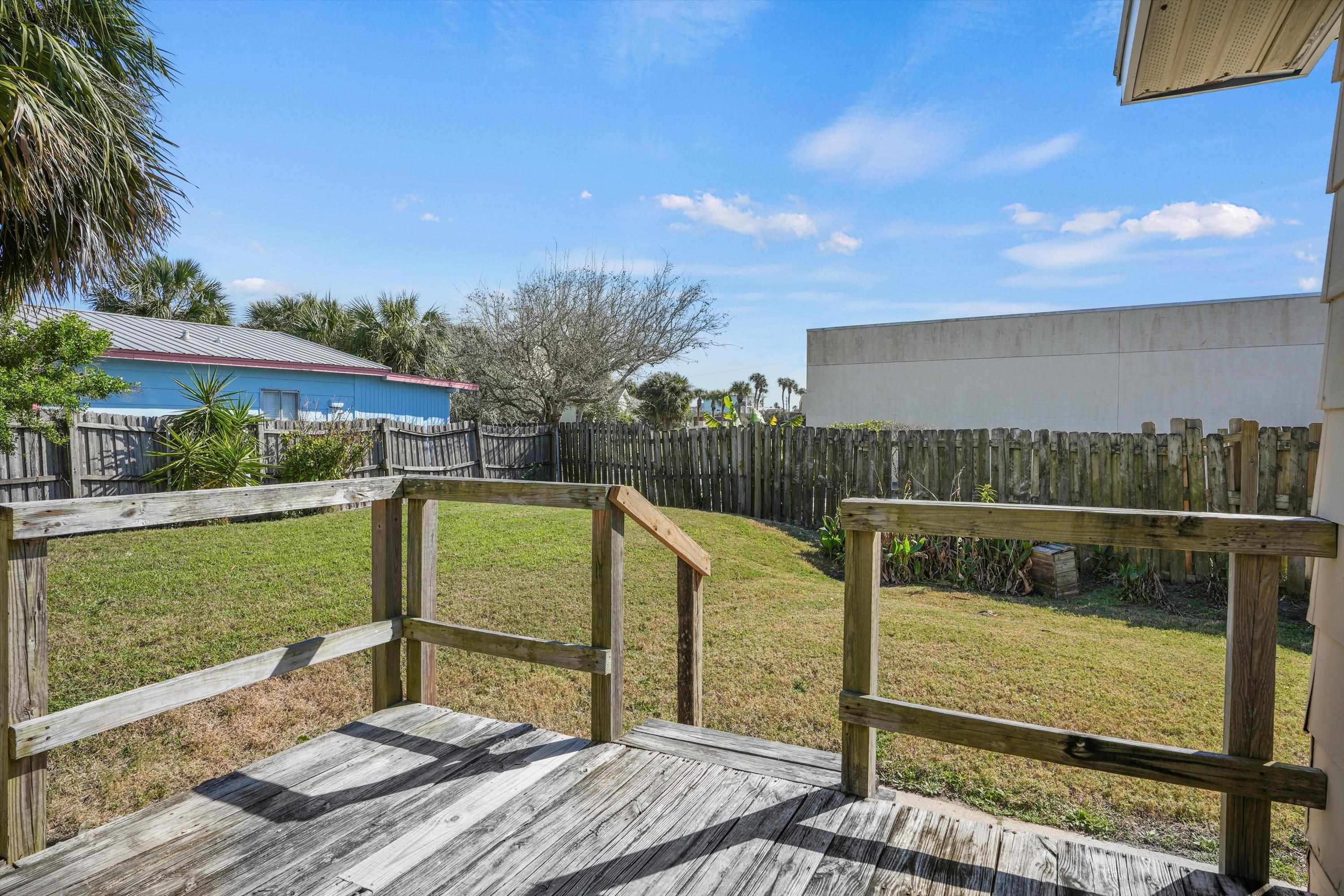 145 Gassett Road St. Augustine, FL 32080 - Photo 3 of 25 a view of a deck with a floor to ceiling window next to a yard