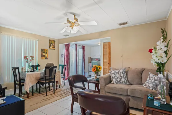 a living room with furniture dining area and a window