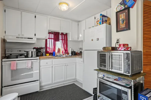 a kitchen with stainless steel appliances a stove a sink and cabinets
