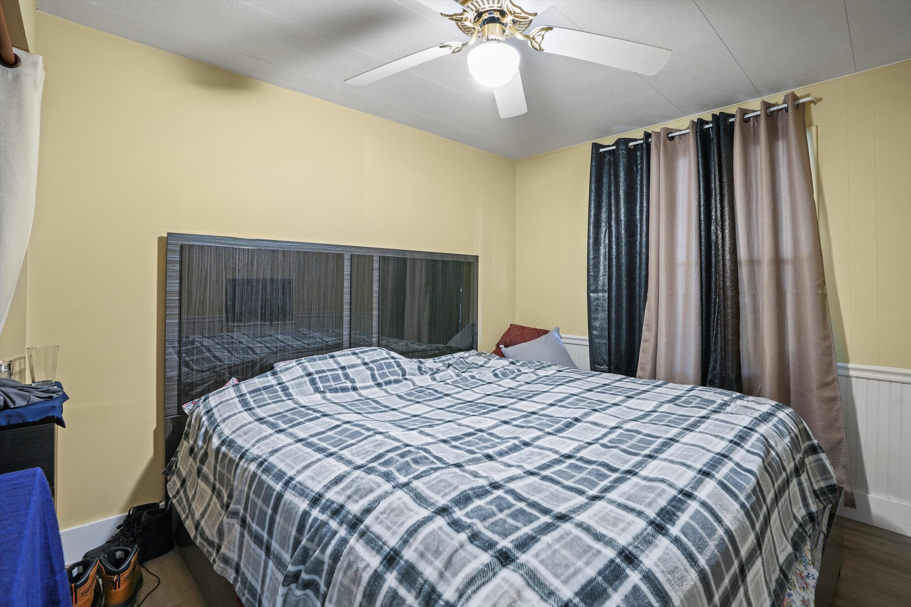 145 Gassett Road St. Augustine, FL 32080 - Photo 9 of 25 a bedroom with a bed and a chandelier