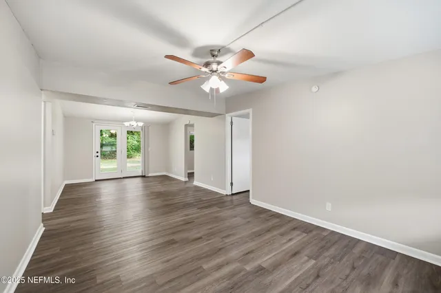 wooden floor in an empty room with a window