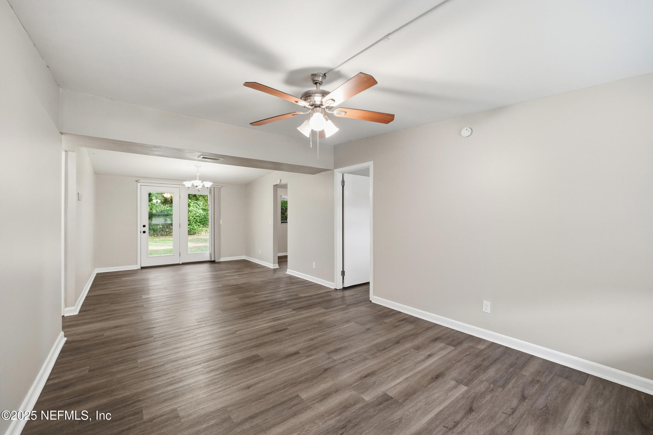 3135 Victoria Park Road Jacksonville, FL 32216 - Photo 4 of 21 wooden floor in an empty room with a window