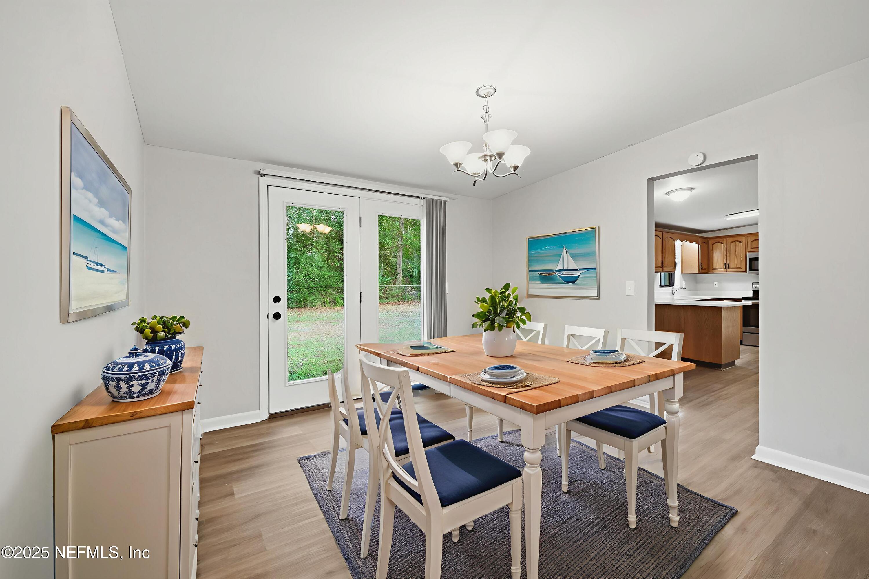 3135 Victoria Park Road Jacksonville, FL 32216 - Photo 5 of 21 a view of a dining room with furniture window and wooden floor