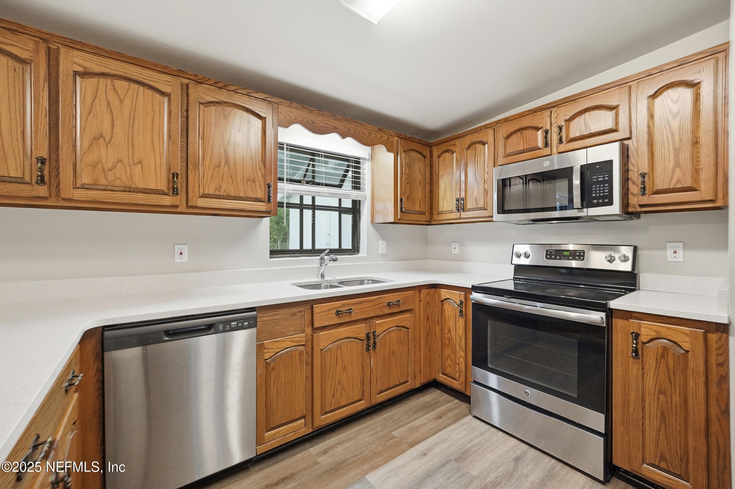 3135 Victoria Park Road Jacksonville, FL 32216 - Photo 8 of 21 a kitchen with stainless steel appliances granite countertop a stove microwave and sink