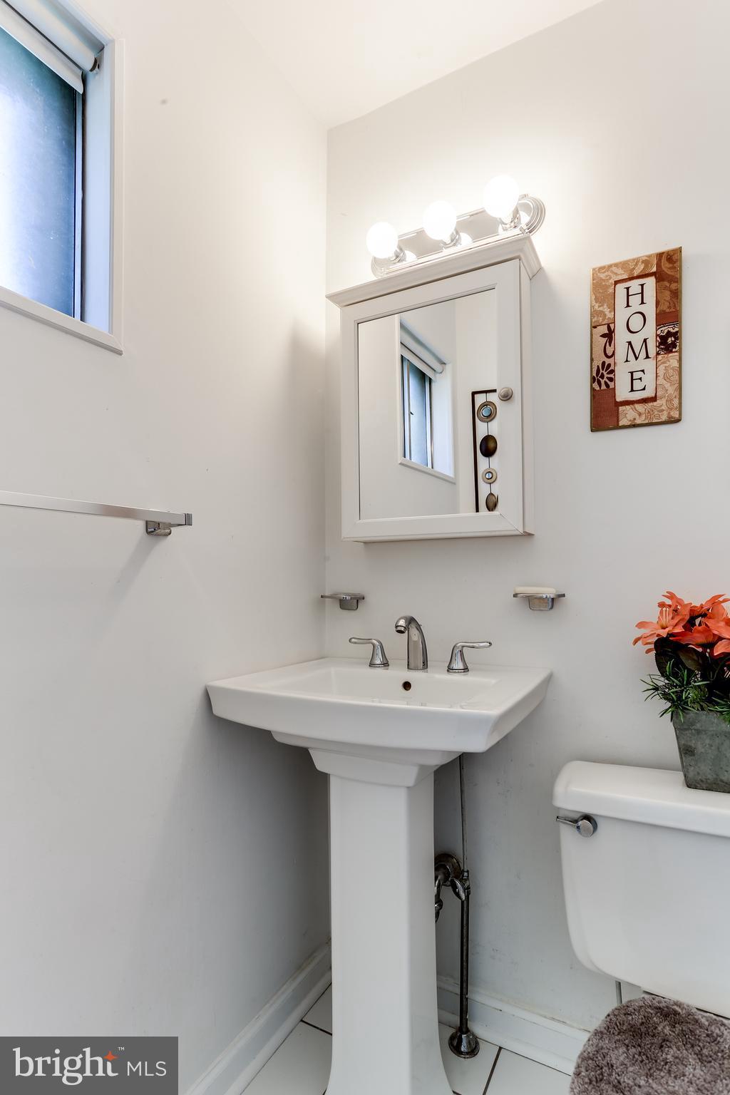 9003 Winands Road Owings Mills, MD 21117 - Photo 15 of 30 a bathroom with a toilet sink and mirror