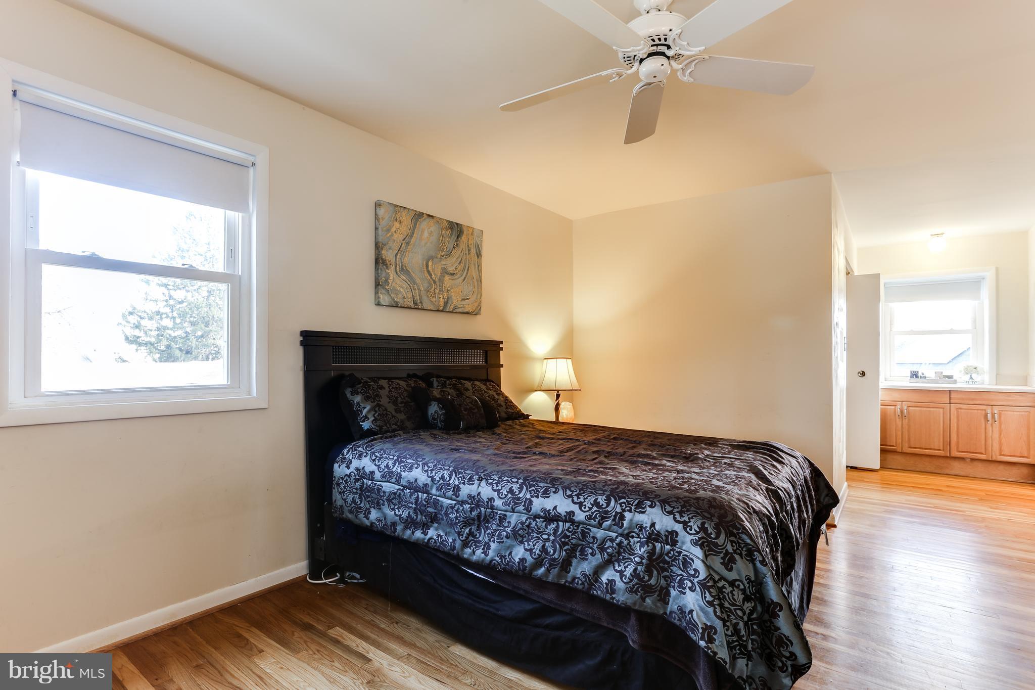 9003 Winands Road Owings Mills, MD 21117 - Photo 18 of 30 a bedroom with a bed and wooden floor