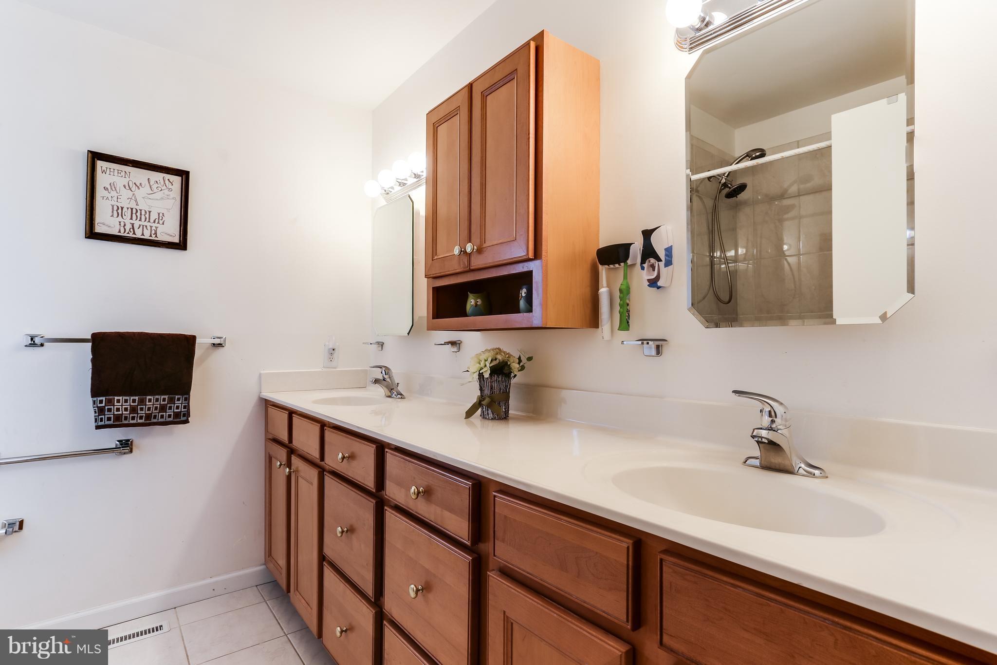 9003 Winands Road Owings Mills, MD 21117 - Photo 20 of 30 a bathroom with a double vanity sink and mirror