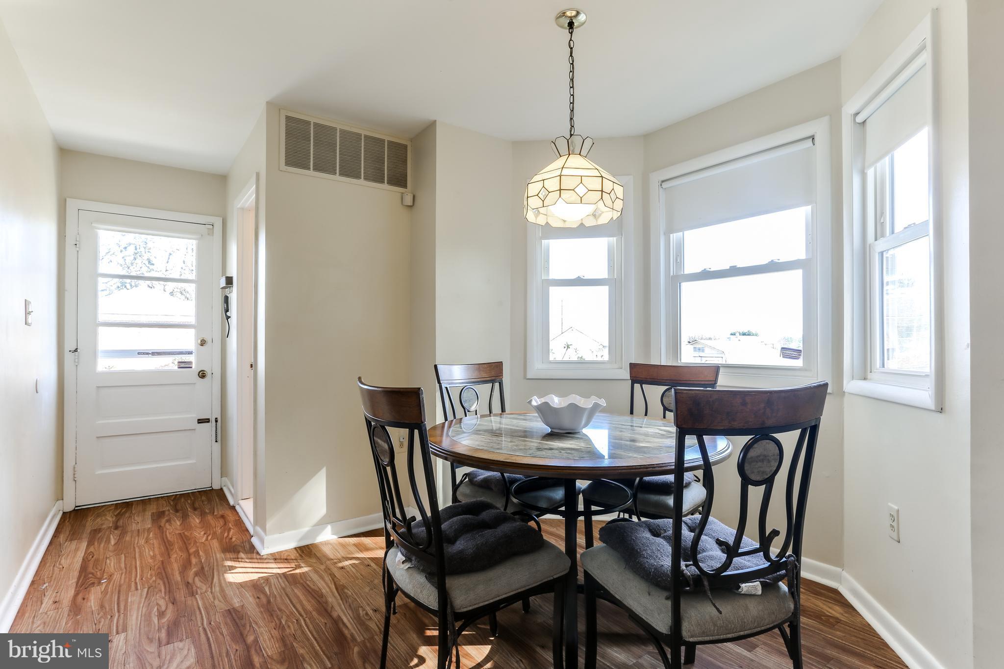 9003 Winands Road Owings Mills, MD 21117 - Photo 3 of 30 a view of a dining room with furniture window and wooden floor