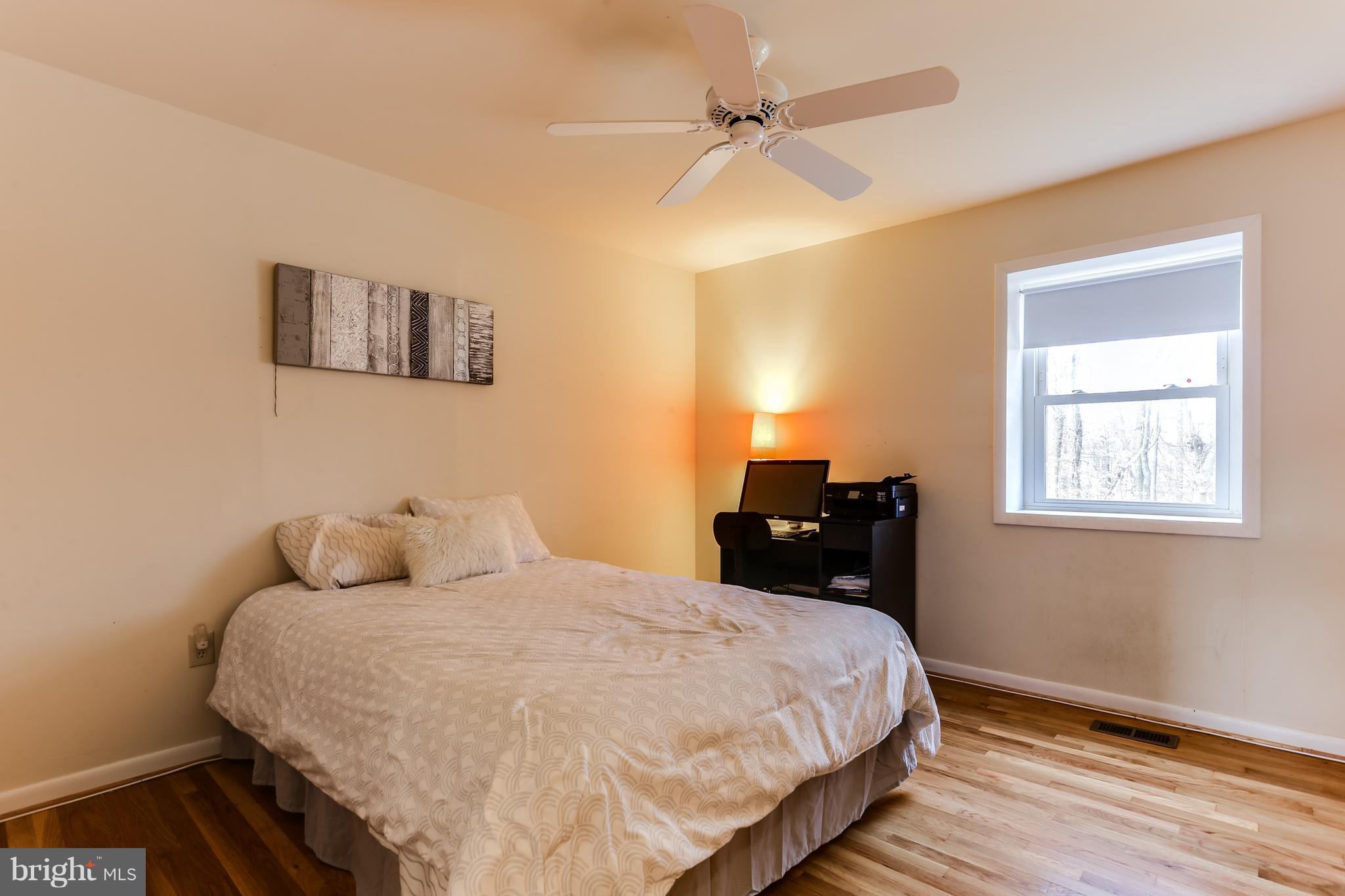 9003 Winands Road Owings Mills, MD 21117 - Photo 24 of 30 a bedroom with a bed and wooden floor