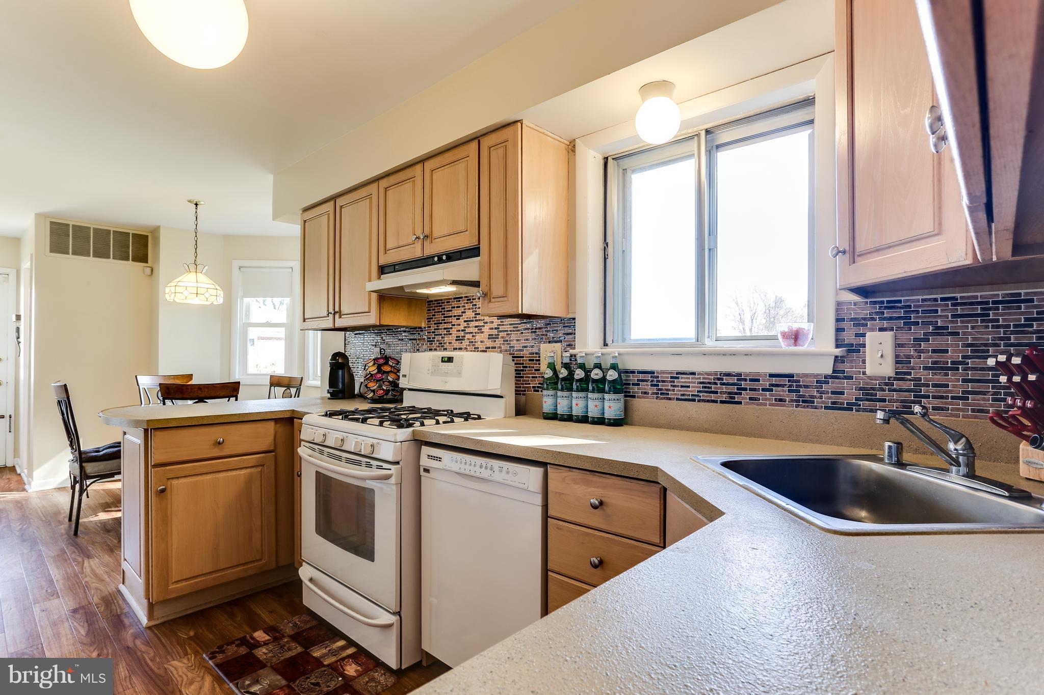 9003 Winands Road Owings Mills, MD 21117 - Photo 5 of 30 a kitchen with a sink stove top oven and cabinets