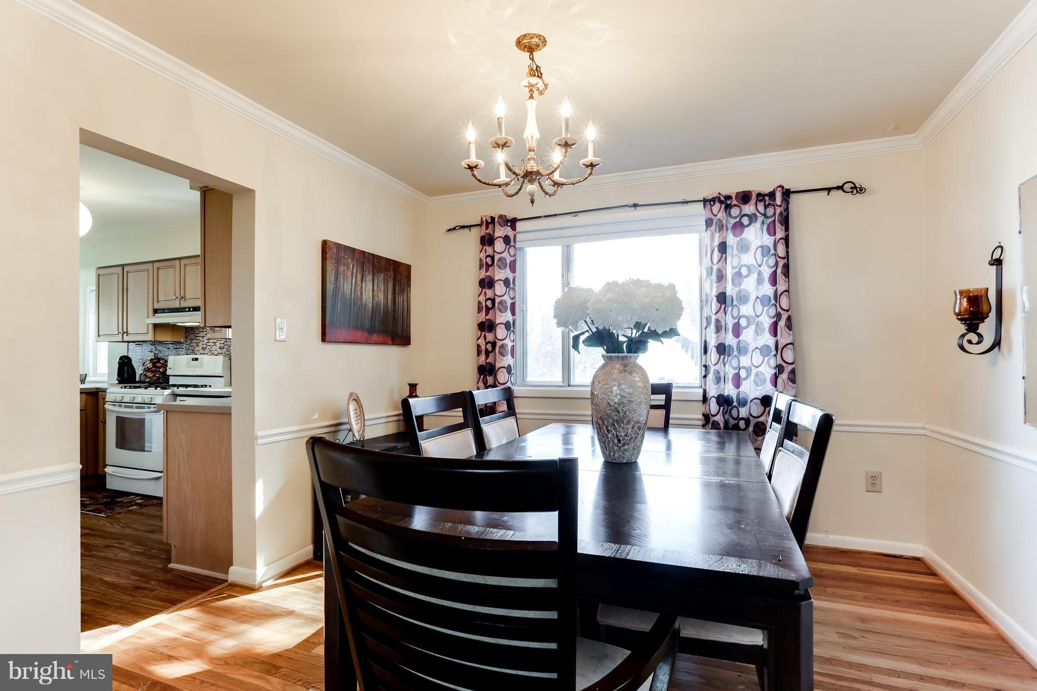 9003 Winands Road Owings Mills, MD 21117 - Photo 7 of 30 a view of a dining room with furniture window and wooden floor