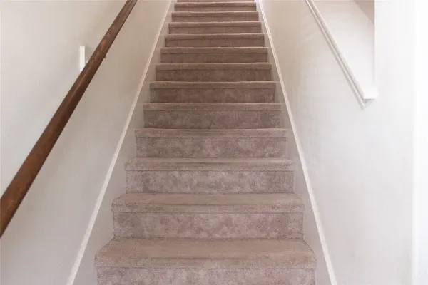 a view of staircase with white walls