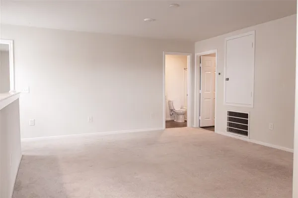 a view of an empty room with a fireplace