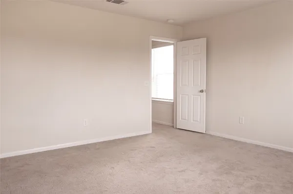 a view of an empty room and entryway