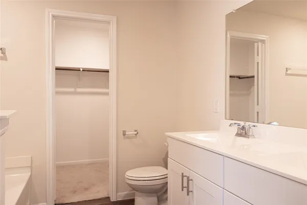 a bathroom with a sink toilet and vanity