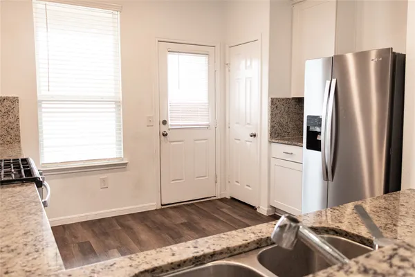 a view of a kitchen with a refrigerator and window