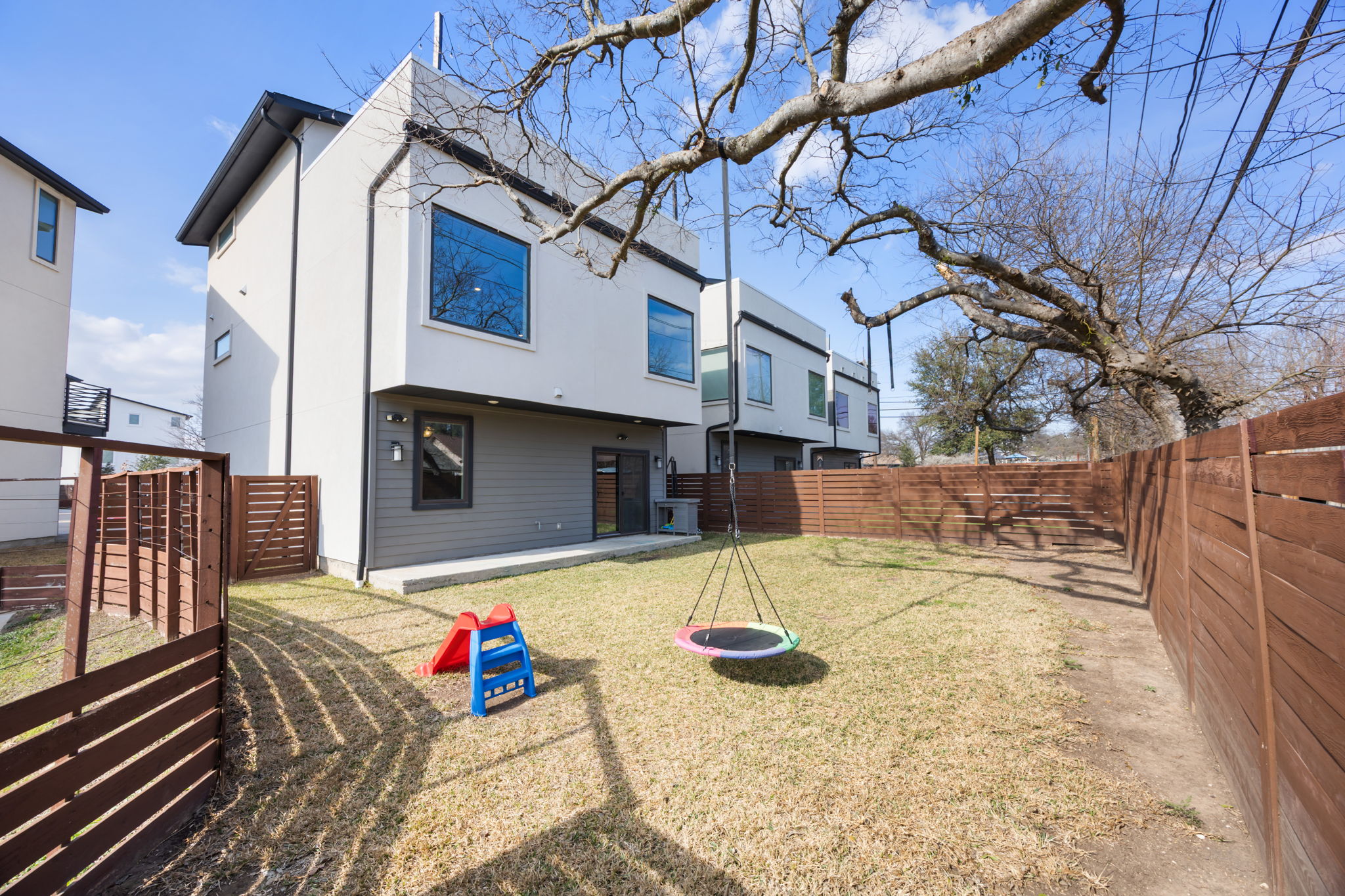 1417 Kramer Lane, Unit 14 Austin, TX 78758 - Photo 28 of 33 Rear view of property featuring a fenced backyard and a patio area
