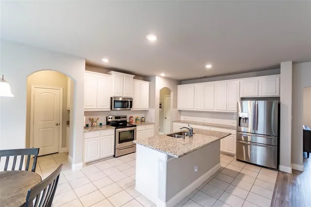 a kitchen with a refrigerator sink and stove