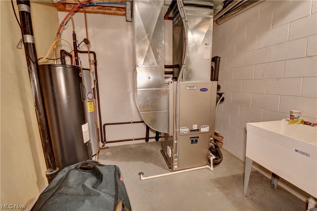 4301 Murray Road Dover, OH 44622 - Photo 36 of 49 Utility room with water heater and sink