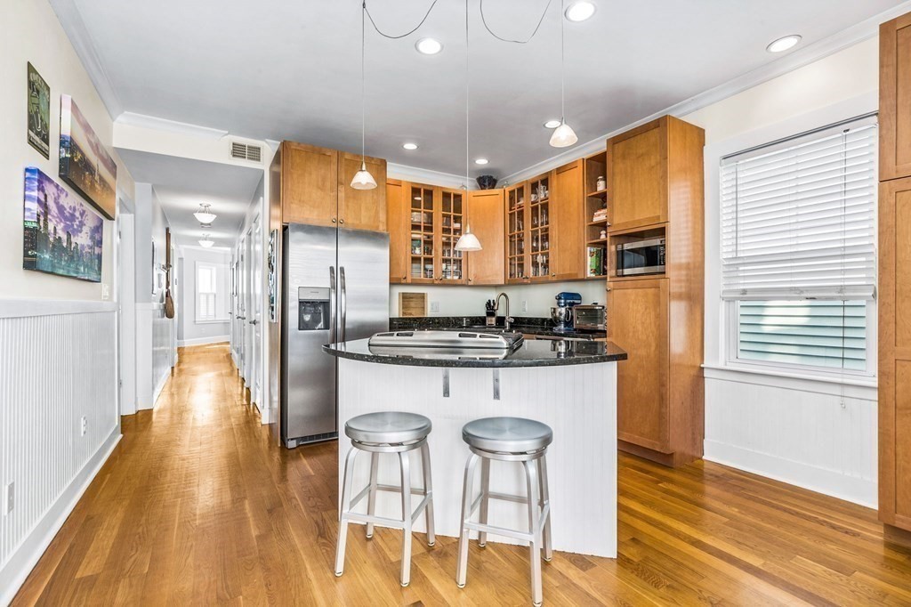 472 East 8th Street, Unit 2 Boston, MA 02127 - Photo 5 of 12 a kitchen with stainless steel appliances granite countertop a sink and a refrigerator