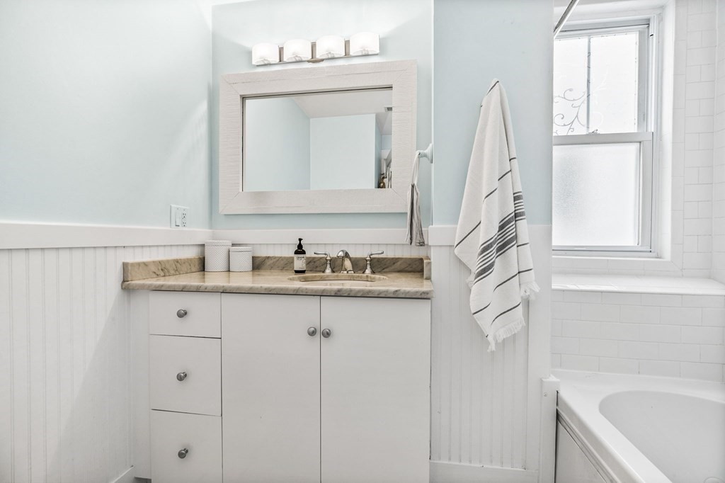 472 East 8th Street, Unit 2 Boston, MA 02127 - Photo 10 of 12 a bathroom with a sink vanity tub and a mirror