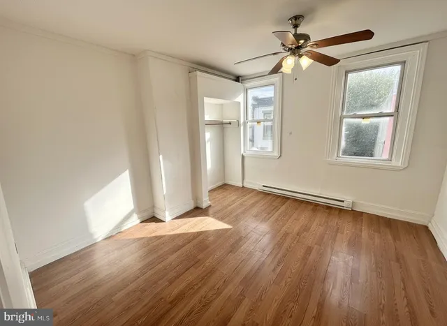 wooden floor in an empty room with a window