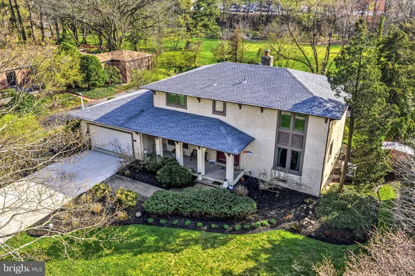 an aerial view of a house with yard and green space