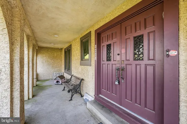 a view of a livingroom with furniture staircase wooden floor and windows