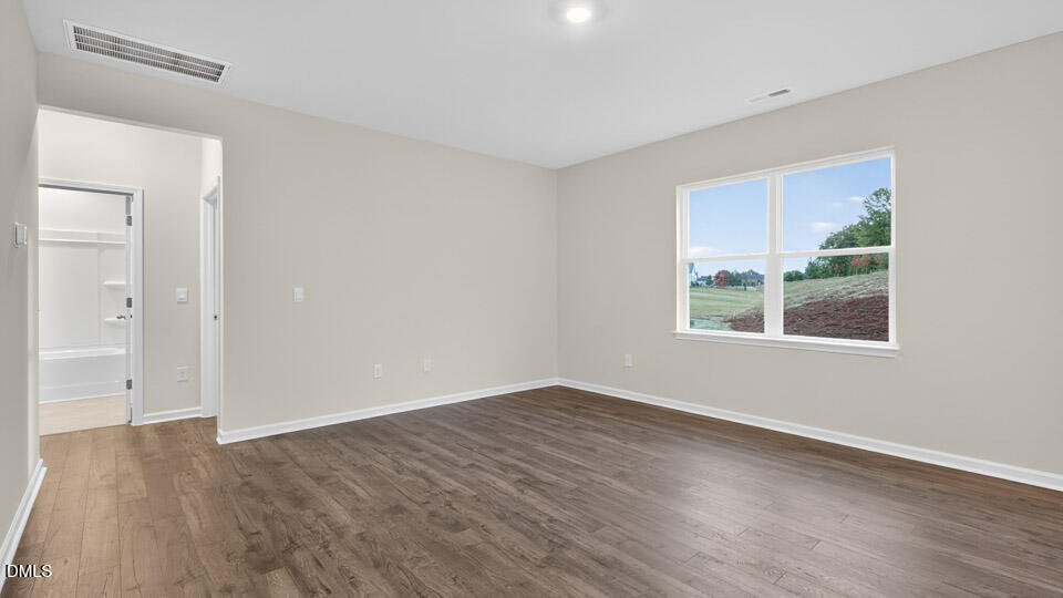 33 Stone Apiary Drive Angier, NC 27501 - Photo 12 of 45 a view of an empty room with wooden floor and windows