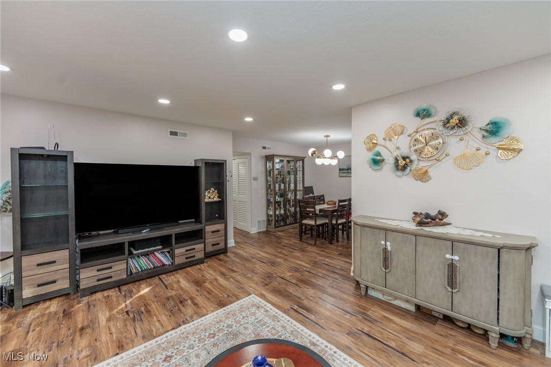 22958 Maple Ridge Road, Unit 209 North Olmsted, OH 44070 - Photo 8 of 38 Living room featuring recessed lighting, wood finished floors, and a chandelier