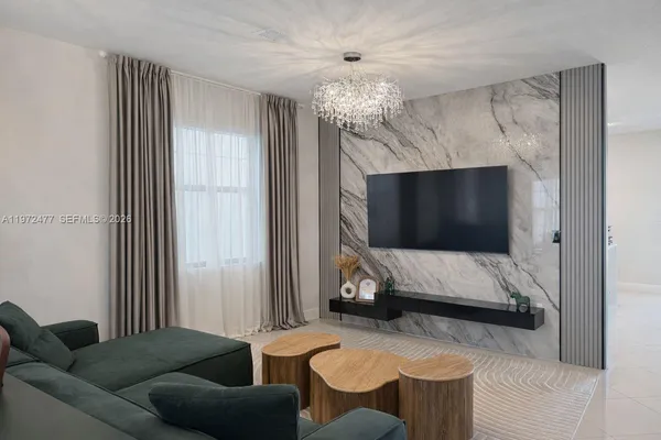 a living room with furniture and a chandelier