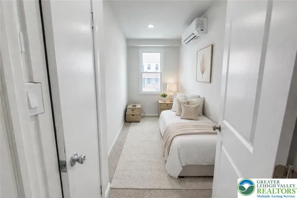 a bedroom with a bed and a mirror