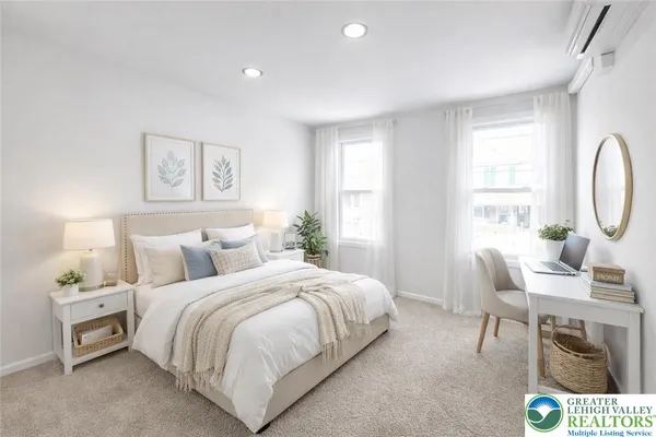 a bedroom with a bed a table and chair